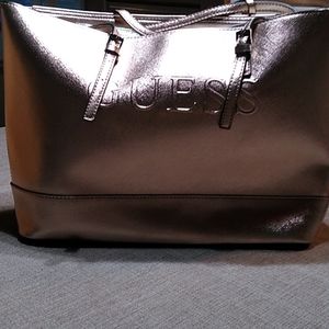 Guess rose gold metallic satchel.  A dust cover included